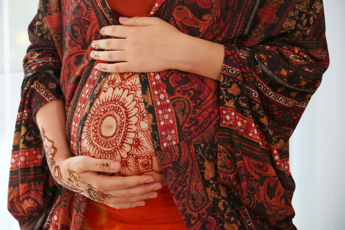 Young Pregnant Woman with Henna Tattoo on Belly 